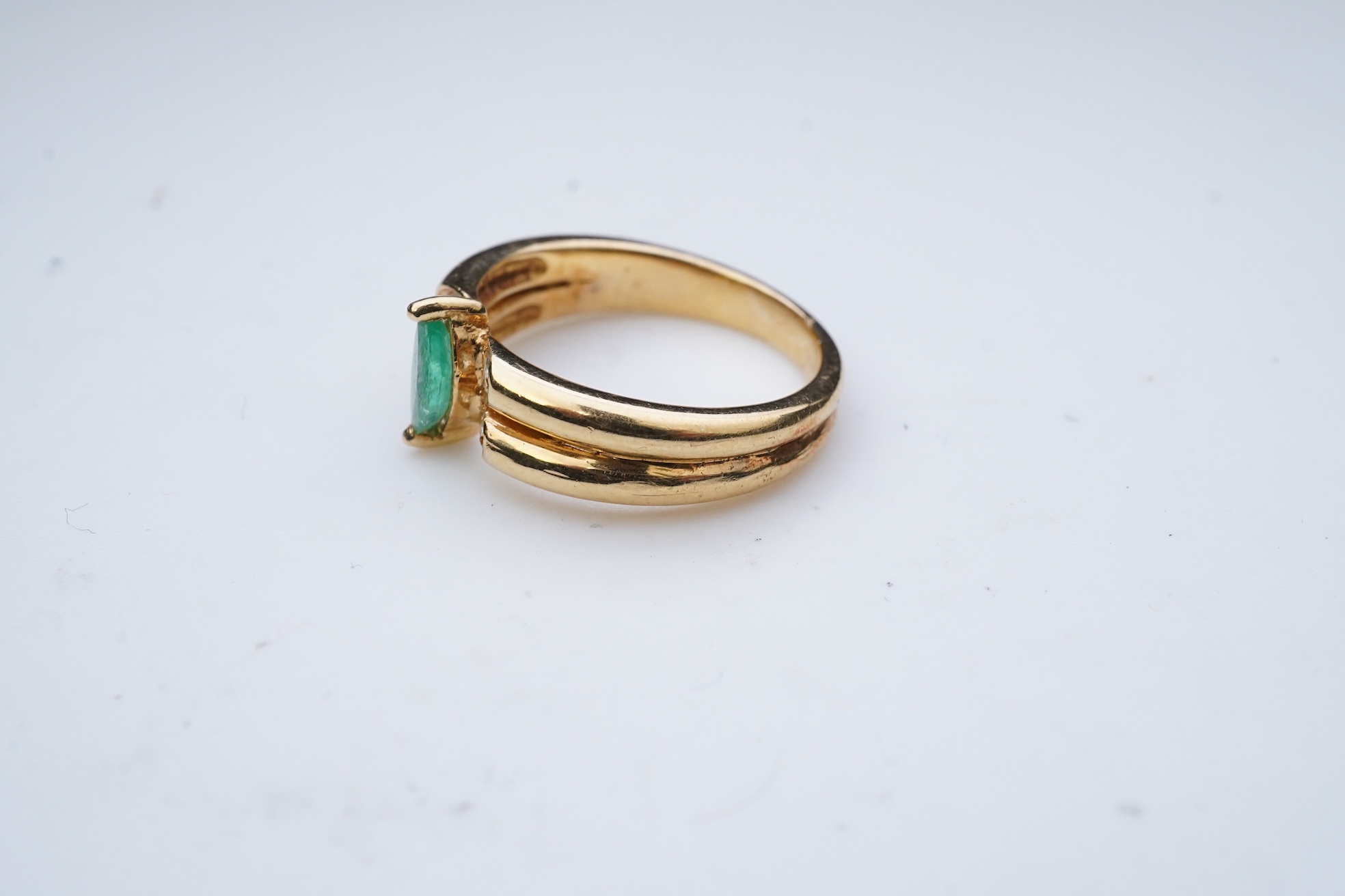 An emerald and diamond ring